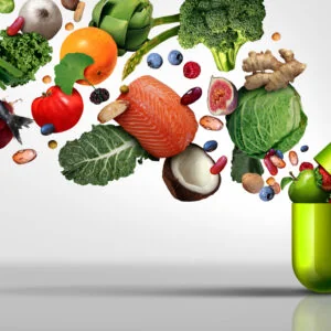 Nutritional supplement and vitamin supplements as a capsule with fruit vegetables nuts and beans inside a nutrient pill as…