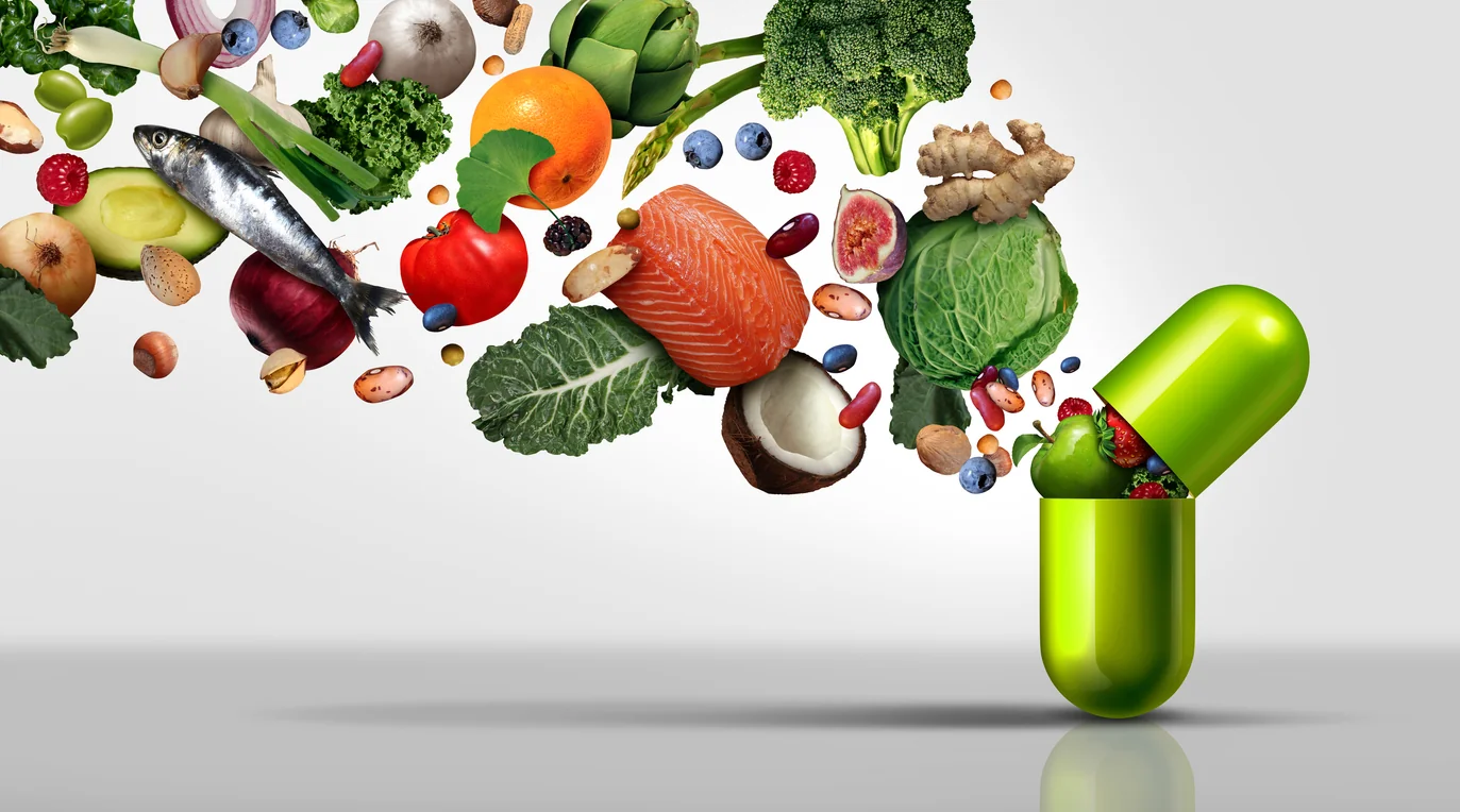 Nutritional supplement and vitamin supplements as a capsule with fruit vegetables nuts and beans inside a nutrient pill as…